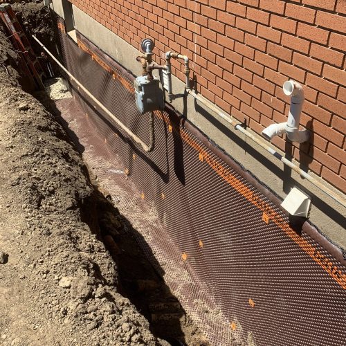 Waterproof membrane along foundation